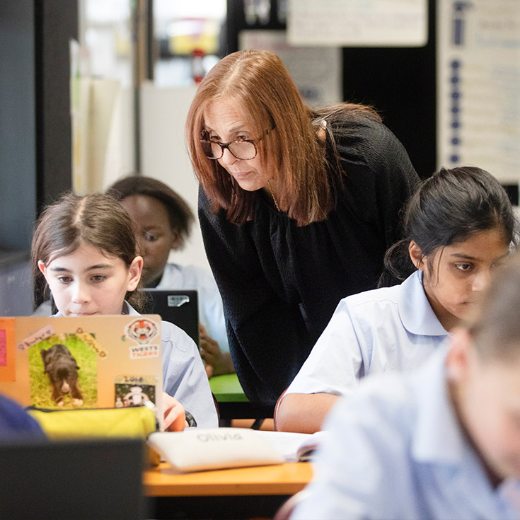 St Bernadette's Catholic Primary School Lalor Park teacher assisting student in class