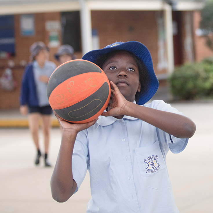 St Bernadette's Catholic Primary School Lalor Park boy playing basketball